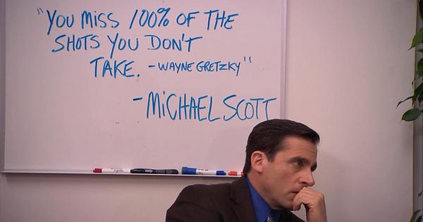 Michael Scott from The Office sat next to a Wayne Gretzky quote written on a white board
