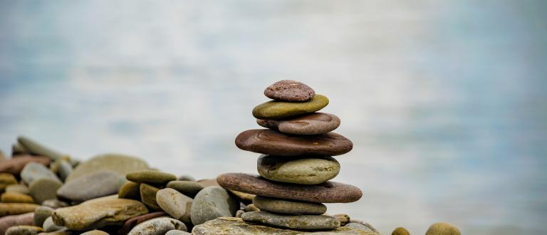 A stack of flat stones by water