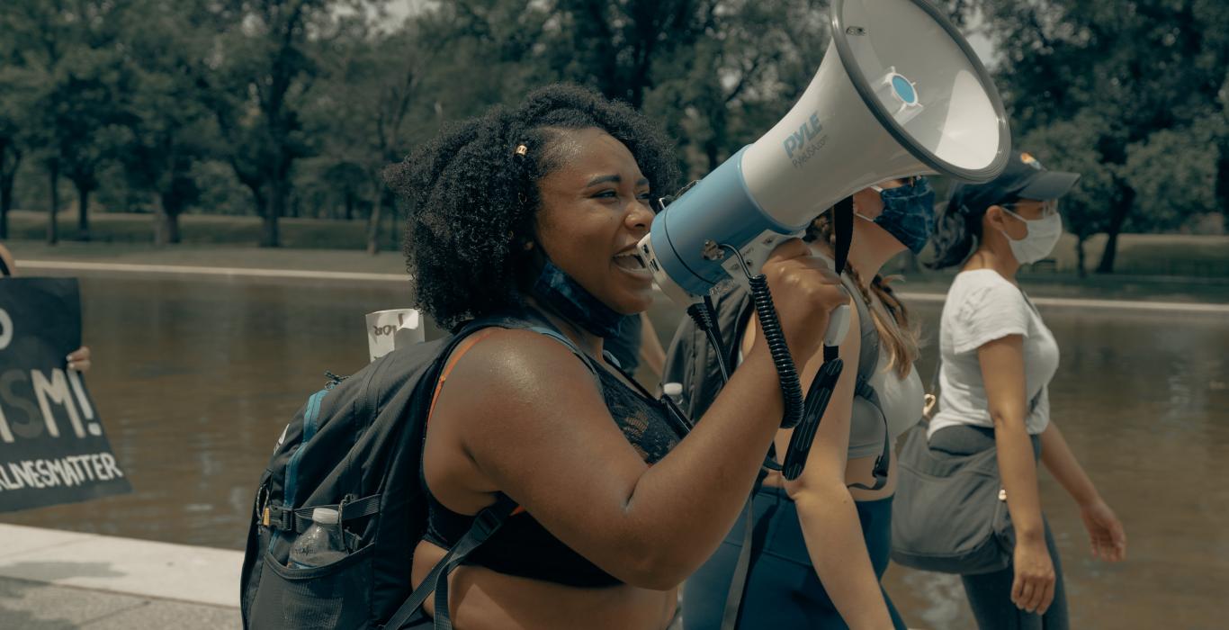Black woman talking into a megaphone